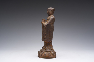 A Chinese cast iron sculpture of a Luohan, probably Ming