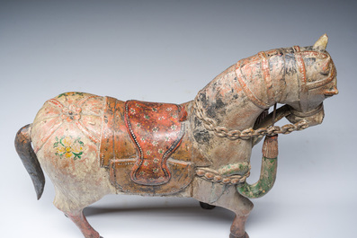 Two Indian polychrome decorated and patinated wooden horses, 20th C.