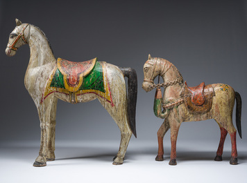 Two Indian polychrome decorated and patinated wooden horses, 20th C.