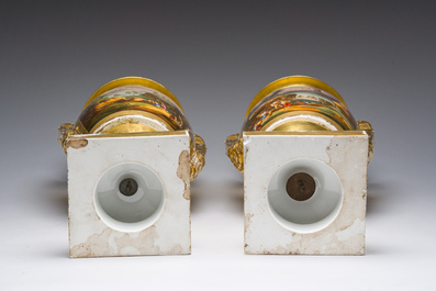 A pair of fine gilt and polychrome Paris porcelain 'animated landscapes' Empire vases, first half 19th C.