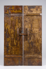 Two black-lacquered and polychromed wooden doors with boys holding a vase and a censer, Tibet, 19th C.