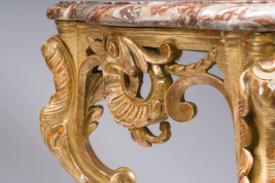 A pair of French carved gilt wooden Louis XV consoles with marble tops, 18th C.