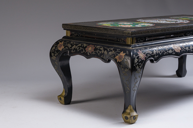 A Chinese rectangular lacquered wooden table with three cloisonn&eacute; plaques, 20th C.