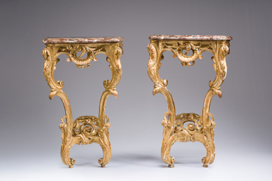 A pair of French carved gilt wooden Louis XV consoles with marble tops, 18th C.