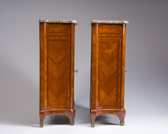 A pair of French Louis XVI style single door hall cabinets with floral marquetry, gilt bronze mounts and marble tops, 19th C.