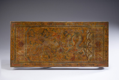A Chinese low table with partly polychromed wooden top with engraved dragon and phoenix design, Qing and 20th C.