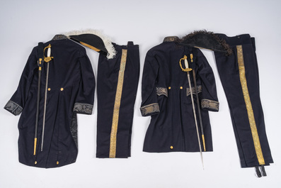 Two Belgian ceremonial costumes with bicorn hats and sables, 19th/20th C.
