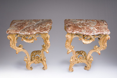 A pair of French carved gilt wooden Louis XV consoles with marble tops, 18th C.