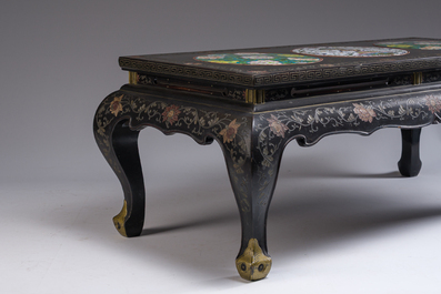 A Chinese rectangular lacquered wooden table with three cloisonn&eacute; plaques, 20th C.
