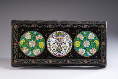 A Chinese rectangular lacquered wooden table with three cloisonn&eacute; plaques, 20th C.