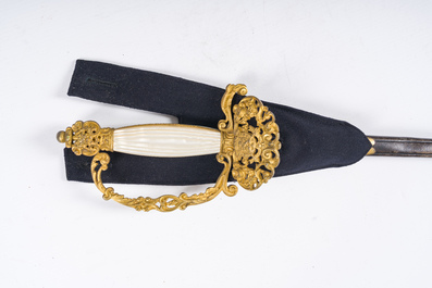 Two Belgian ceremonial costumes with bicorn hats and sables, 19th/20th C.