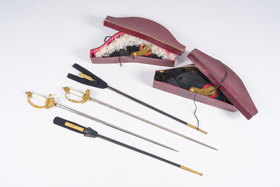 Two Belgian ceremonial costumes with bicorn hats and sables, 19th/20th C.