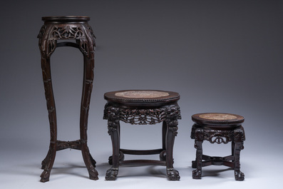 Three Chinese reticulated wooden stands with marble tops, 20th C.