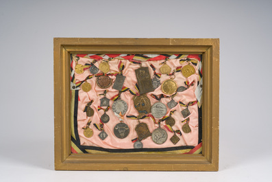 Two framed collections of medals and awards won in Belgian sports and baking competitions, 20th C.