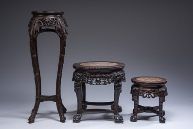 Three Chinese reticulated wooden stands with marble tops, 20th C.