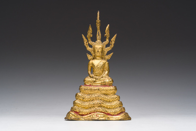 A Thai gilt bronze figure of Buddha seated on the Naga throne, Rattanakosin, 19th C.