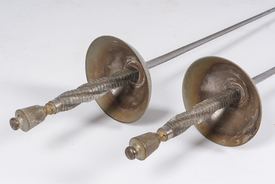 A pair of Belgian decorative &eacute;p&eacute;es with twisted handles and engraved floral design on the occasion of the fencing gala in Beauraing, dated 1899