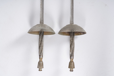 A pair of Belgian decorative &eacute;p&eacute;es with twisted handles and engraved floral design on the occasion of the fencing gala in Beauraing, dated 1899
