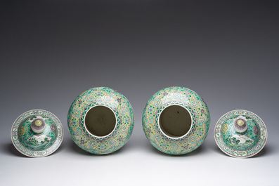 A pair of Chinese verte biscuit vases and covers with landscapes and floral design, 19th C.