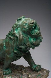 Belgian school, Van den Balck (19th/20th C.): A roaring lion on a rock struck by arrows, green and gray patinated plaster, Brussels
