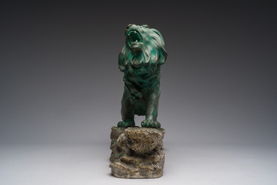 Belgian school, Van den Balck (19th/20th C.): A roaring lion on a rock struck by arrows, green and gray patinated plaster, Brussels