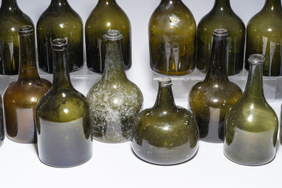 Sixteen Dutch and Flemish green glass wine bottles, 17th/19th C.