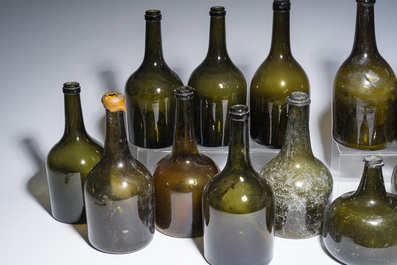 Sixteen Dutch and Flemish green glass wine bottles, 17th/19th C.