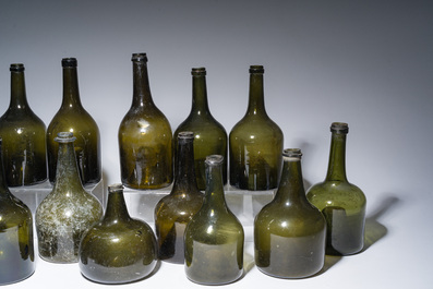 Sixteen Dutch and Flemish green glass wine bottles, 17th/19th C.