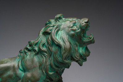 Belgian school, Van den Balck (19th/20th C.): A roaring lion on a rock struck by arrows, green and gray patinated plaster, Brussels