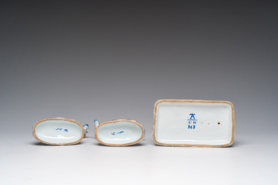 A blue and white Dutch Delft model of a seated dog and a pair of polychrome cows, 19th C.