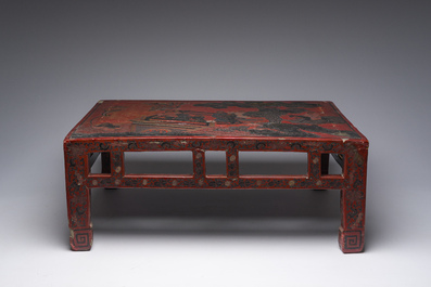 A Chinese rectangular lacquered wooden low table with figures in a garden, 19th/20th C.
