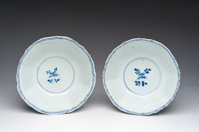 Een paar Chinese blauw-witte kommen met geanimeerde landschappen en floraal decor, Kangxi