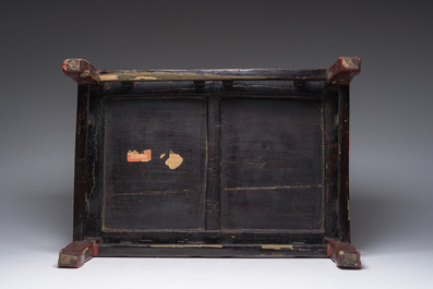 A Chinese rectangular lacquered wooden low table with figures in a garden, 19th/20th C.