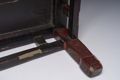 A Chinese rectangular lacquered wooden low table with figures in a garden, 19th/20th C.