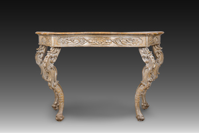 An Italian patinated wooden console with a faux marble top and lion paws, 18th C.