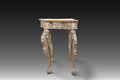 An Italian patinated wooden console with a faux marble top and lion paws, 18th C.