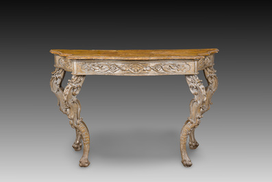 An Italian patinated wooden console with a faux marble top and lion paws, 18th C.