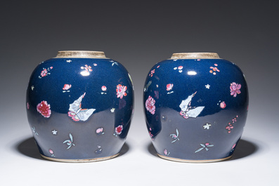 A pair of Chinese blue ground jars with enamelled decoration of butterflies and flowers, 19th C.