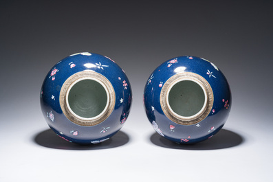 A pair of Chinese blue ground jars with enamelled decoration of butterflies and flowers, 19th C.