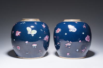A pair of Chinese blue ground jars with enamelled decoration of butterflies and flowers, 19th C.