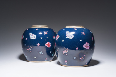 A pair of Chinese blue ground jars with enamelled decoration of butterflies and flowers, 19th C.
