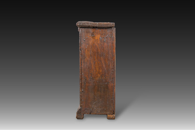 A carved oak one-door cupboard with the central panel carved with two heads, probably Germany, 16th C.