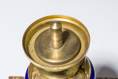 Three French gold layered blue ground gilt bronze mounted S&egrave;vres style vases and covers with gallant scenes, 20th C.