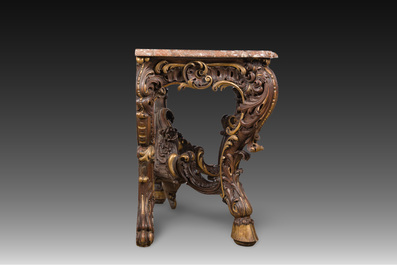 An impressive parcel-gilt and patinated wooden console in Rococo style, probably Italy, 19th C.