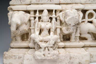 An Indian white marble Jain temple sculpture fragment with Jina flanked by elephants and a mythical lion, probably Gujarat, 15th/16th C.