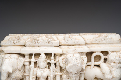 An Indian white marble Jain temple sculpture fragment with Jina flanked by elephants and a mythical lion, probably Gujarat, 15th/16th C.