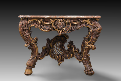 An impressive parcel-gilt and patinated wooden console in Rococo style, probably Italy, 19th C.