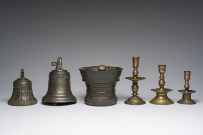 Two bells, a mortar and stamper, three candlesticks and an alms dish in bronze and brass, 17th/19th C.