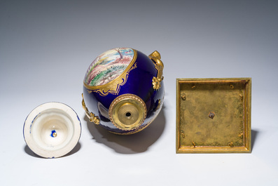 Three French gold layered blue ground gilt bronze mounted S&egrave;vres style vases and covers with gallant scenes, 20th C.