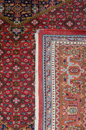 A Persian Bidjar rug with floral design, wool on cotton, 20th C.